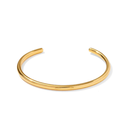 Pulsera minimalista abierta chapada en oro